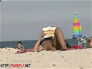 red-hot stunners filmed lounging on a nudist beach